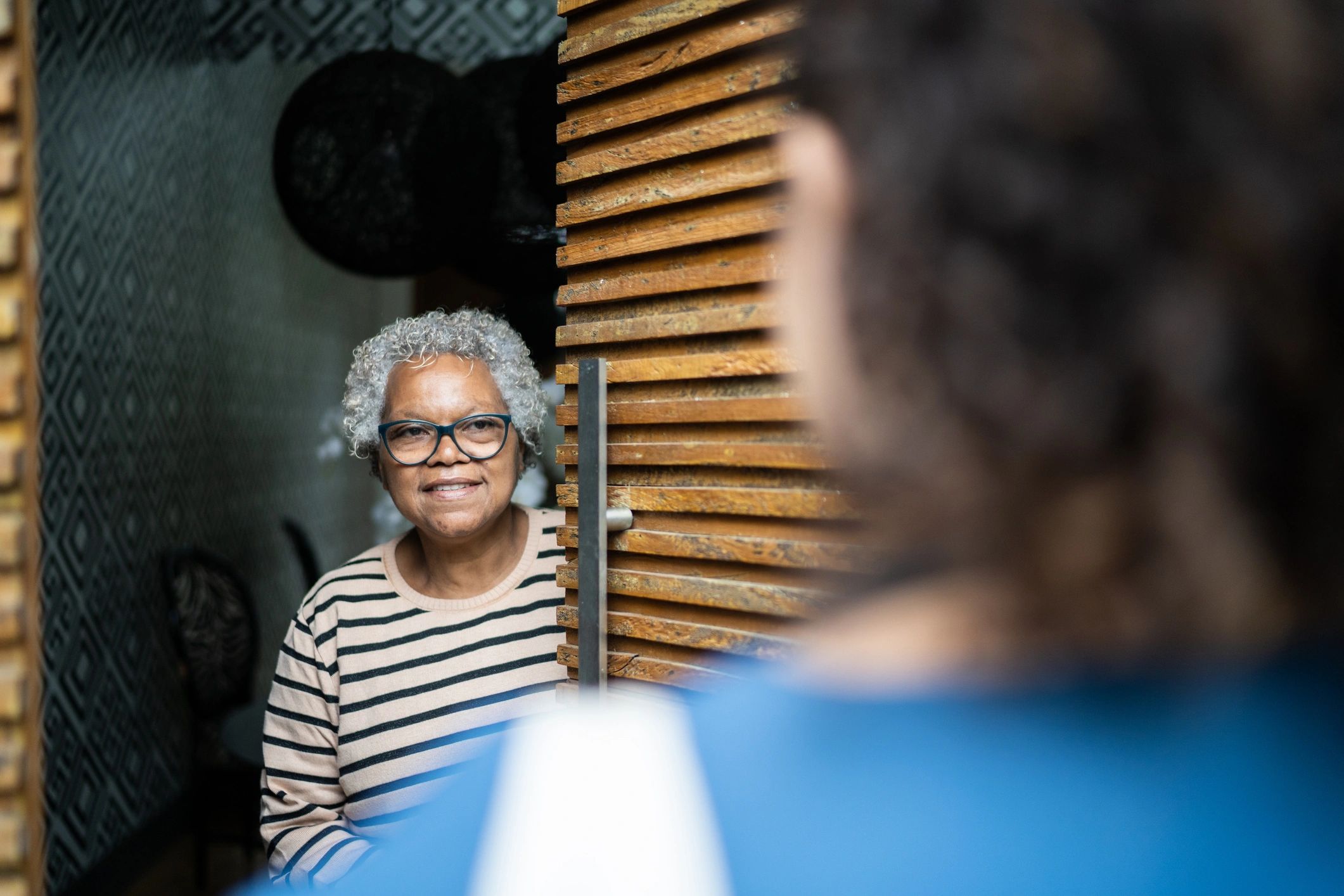 Volunteer delivering groceries to a senior at her front door