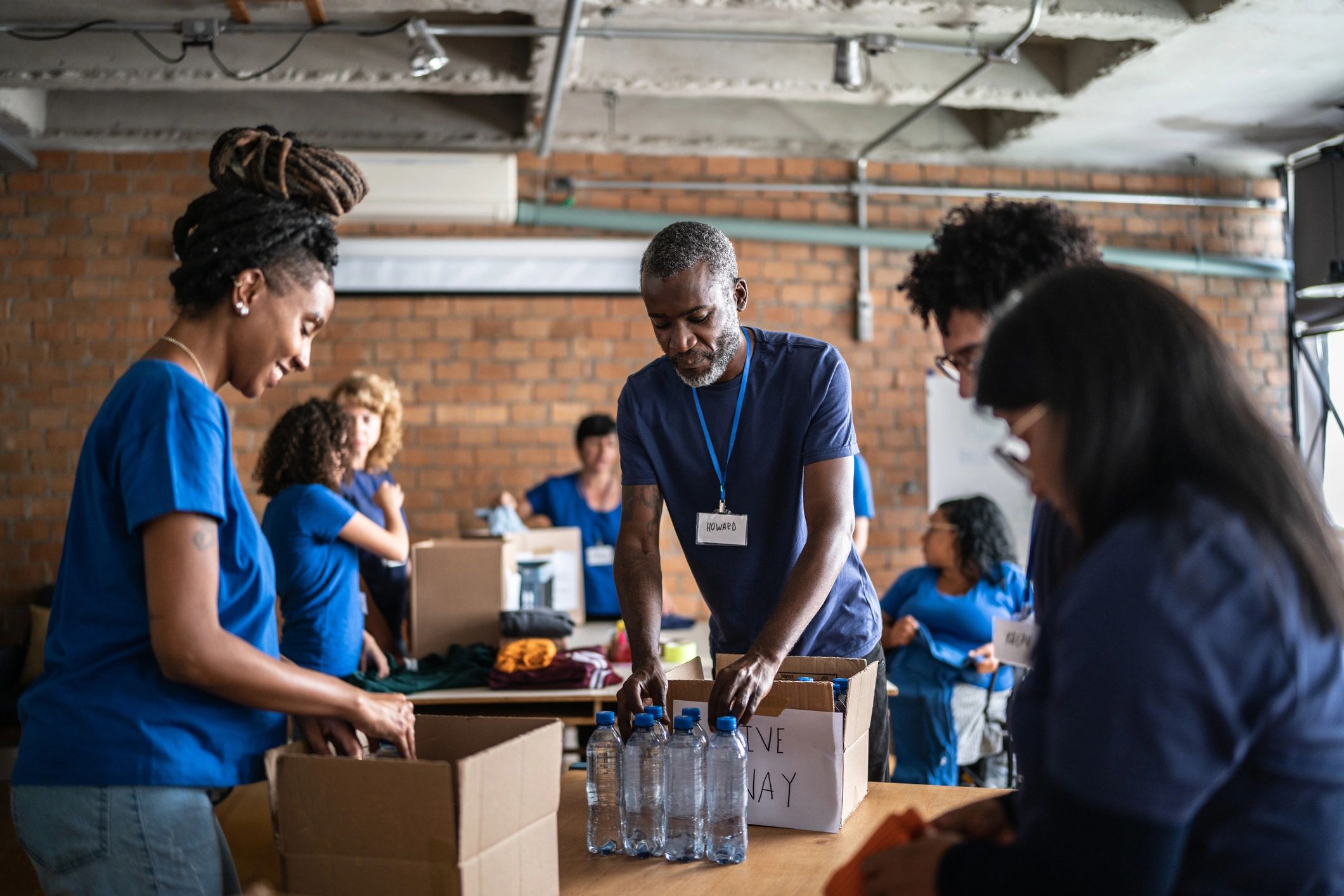 Volunteers arranging donations at a community charity center