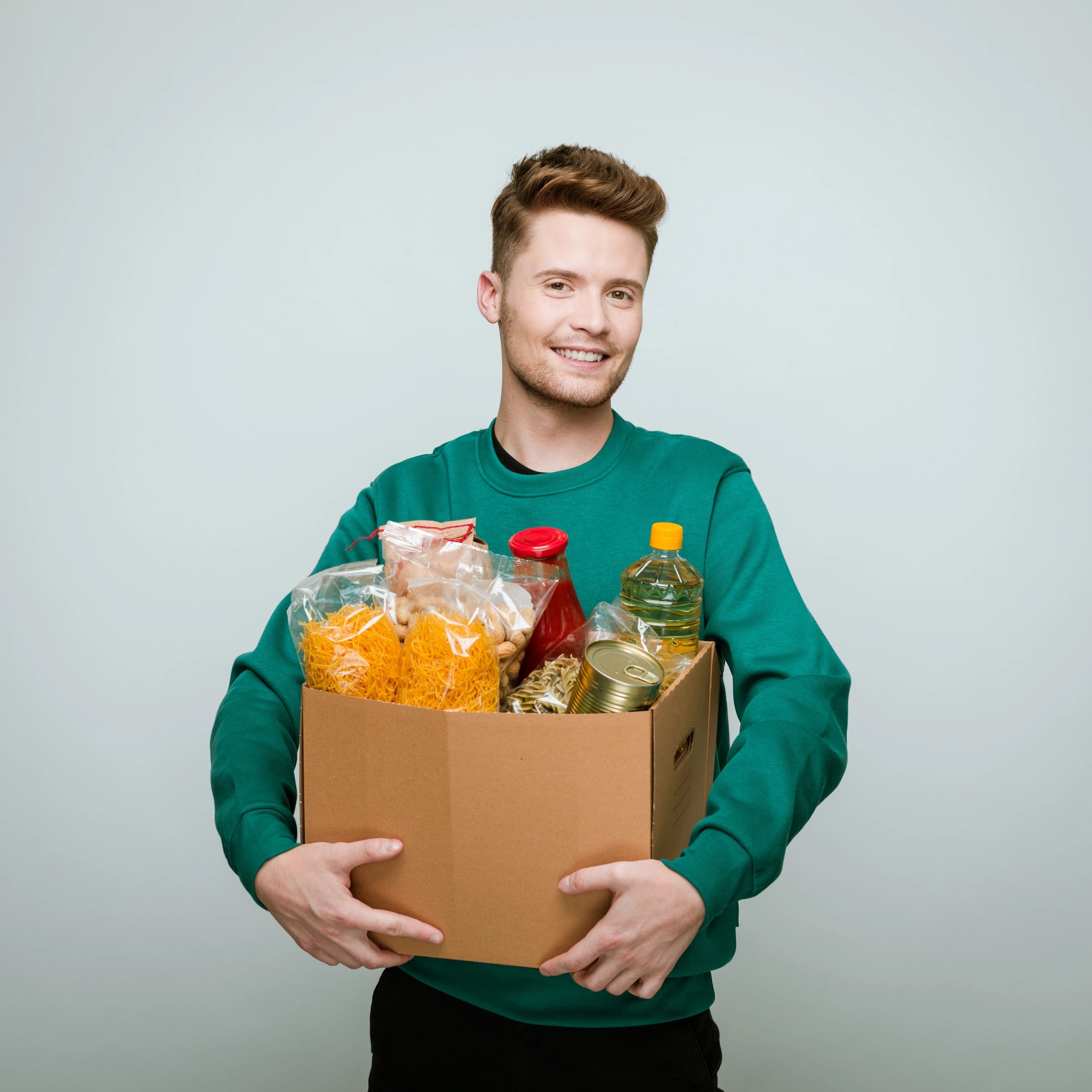 Volunteer holding a box of donated food