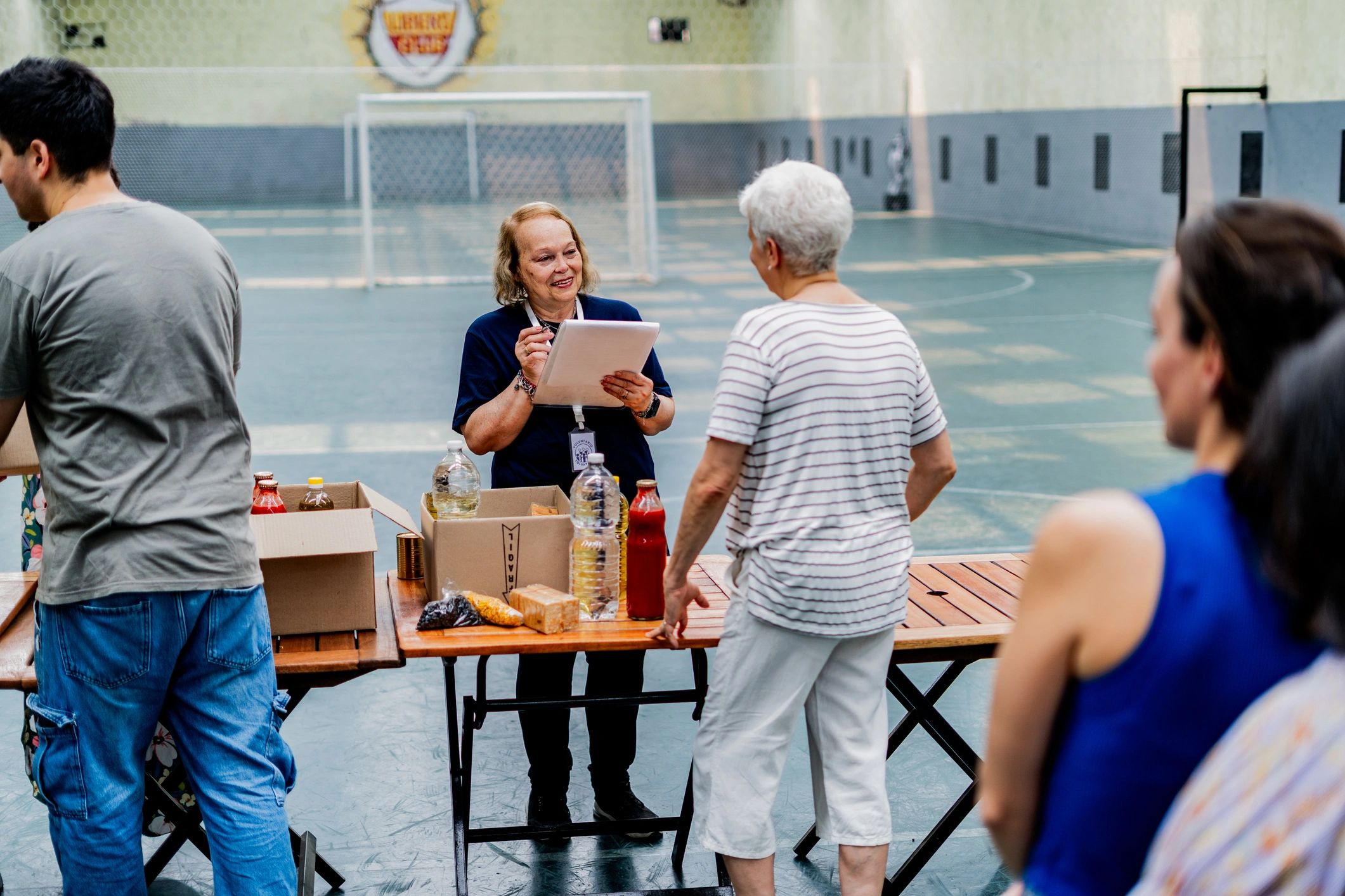 Volunteer and senior connecting during a community donation event