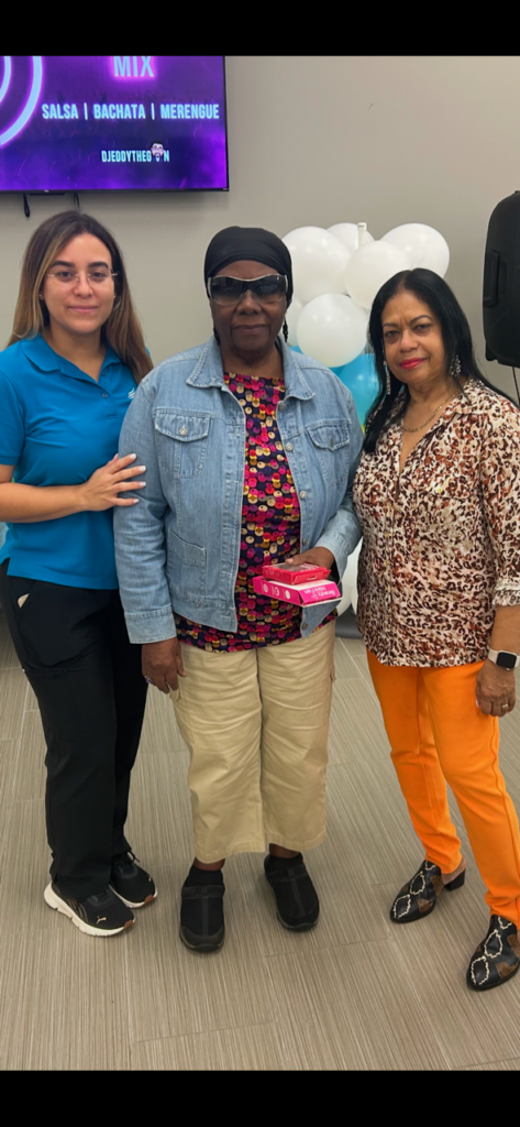 Three women posing at an event.